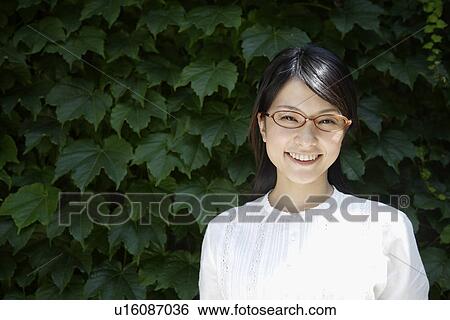 Portrait of a young woman smiling View Large Photo Image Stock Photograph - Portrait of a young woman smiling. Fotosearch