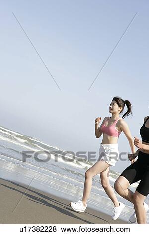 Two women jogging on the seashore View Large Photo Image Stock Photo - Two women jogging on the seashore. Fotosearch