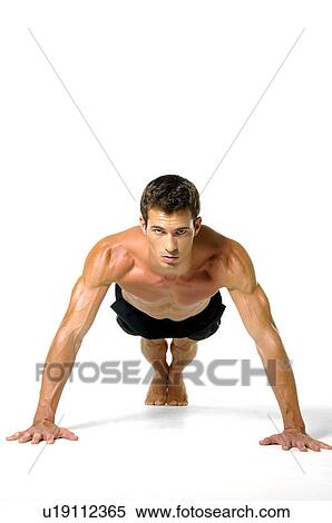 Stock Photography - Portrait of a young man doing push-ups. Fotosearch
