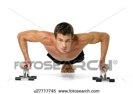 Stock Photography - Portrait of a young man doing push-ups. Fotosearch