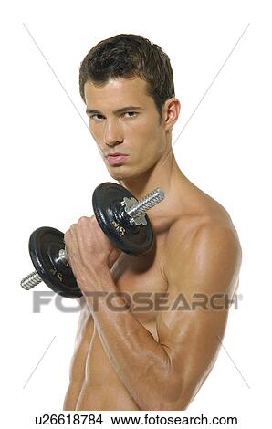 Picture - Portrait of a young man exercising with a hand weight. Fotosearch