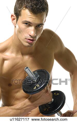 Portrait of a young man exercising with a hand weight View Large Photo Image Stock Photo - Portrait of a young man exercising with a hand weight. Fotosearch