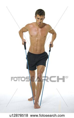Portrait of a young man exercising with a resistance band View Large Photo Image Stock Photo - Portrait of a young man exercising with a resistance band. Fotosearch