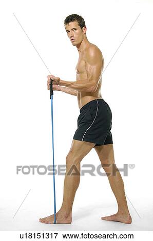 Portrait of a young man exercising with a resistance band View Large Photo Image Stock Photo - Portrait of a young man exercising with a resistance band. Fotosearch