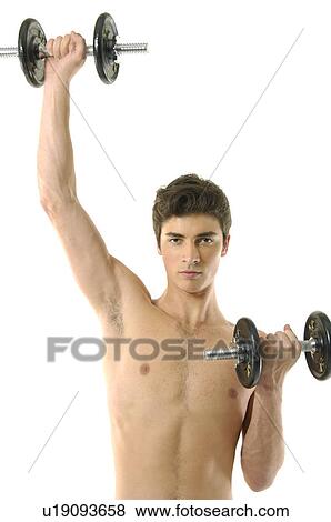 Stock Photo - Portrait of a young man exercising with hand weights. Fotosearch