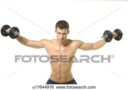 Stock Photograph - Portrait of a young man exercising with hand weights. Fotosearch