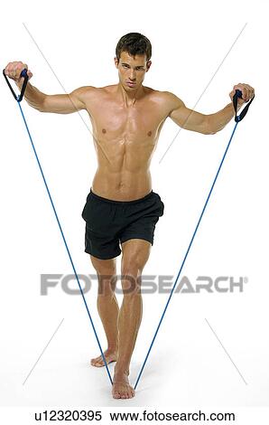 Portrait of a young man exercising with a resistance band View Large Photo Image Stock Photography - Portrait of a young man exercising with a resistance band. Fotosearch