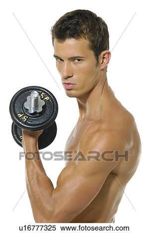 Portrait of a young man exercising with a hand weight View Large Photo Image Stock Photography - Portrait of a young man exercising with a hand weight. Fotosearch