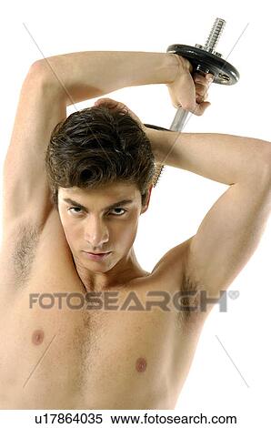 Portrait of a young man exercising with a hand weight View Large Photo Image Stock Photography - Portrait of a young man exercising with a hand weight. Fotosearch