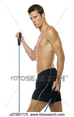 Portrait of a young man exercising with a resistance band View Large Photo Image Stock Photography - Portrait of a young man exercising with a resistance band. Fotosearch