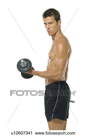 Stock Image - Side profile of a young man exercising with a hand weight. Fotosearch