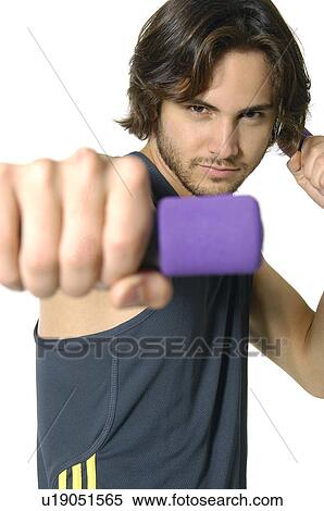 Close-up of a young man exercising with hand weight View Large Photo Image Stock Photography - Close-up of a young man exercising with hand weight. Fotosearch