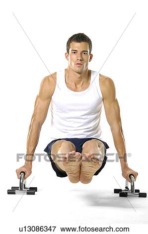 Portrait of a young man exercising View Large Photo Image Stock Photo - Portrait of a young man exercising. Fotosearch