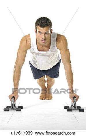 Stock Photo - Portrait of a young man exercising. Fotosearch