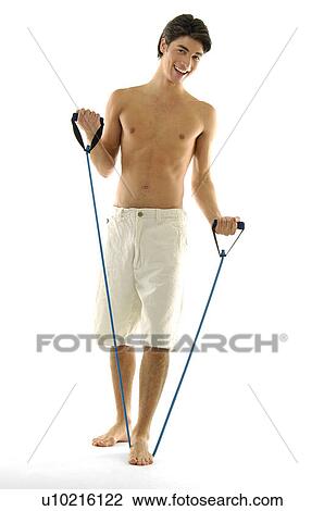 Portrait of a young man exercising with a resistance band View Large Photo Image Stock Image - Portrait of a young man exercising with a resistance band. Fotosearch