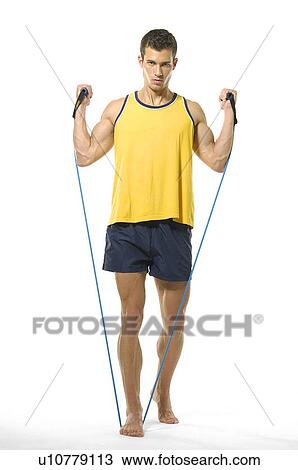 Portrait of a young man exercising with resistance band View Large Photo Image Stock Image - Portrait of a young man exercising with resistance band. Fotosearch