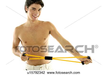 Portrait of a young man exercising with resistance band View Large Photo Image Stock Image - Portrait of a young man exercising with resistance band. Fotosearch