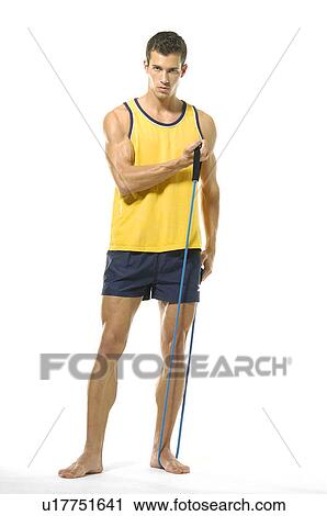 Portrait of a young man exercising with resistance band View Large Photo Image Stock Image - Portrait of a young man exercising with resistance band. Fotosearch