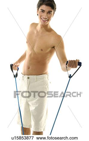 Portrait of a young man exercising with a resistance band View Large Photo Image Stock Photo - Portrait of a young man exercising with a resistance band. Fotosearch