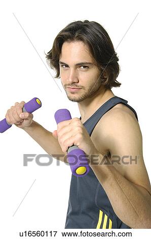 Stock Photo - Portrait of a young man exercising with hand weights. Fotosearch