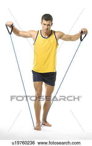 Portrait of a young man exercising with resistance band View Large Photo Image Stock Photograph - Portrait of a young man exercising with resistance band. Fotosearch