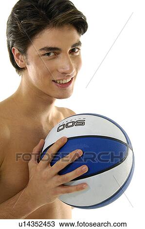 Stock Image - Portrait of a young man playing basketball. Fotosearch