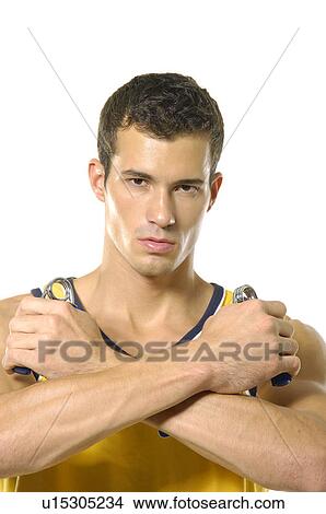 Portrait of a young man squeezing handgrips View Large Photo Image Picture - Portrait of a young man squeezing handgrips. Fotosearch