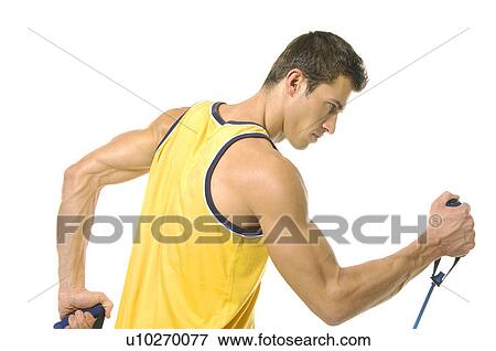 Side profile of a young man exercising with a resistance band View Large Photo Image Stock Photo - Side profile of a young man exercising with a resistance band. Fotosearch