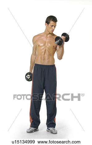 Young man exercising with dumbbells View Large Photo Image Stock Photo - Young man exercising with dumbbells. Fotosearch