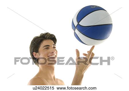 Stock Photography - Young man playing basketball. Fotosearch