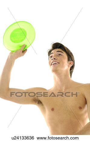 Stock Photograph - Young man playing with a plastic disc. Fotosearch