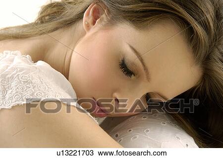 Close-up of a young woman with her eyes closed View Large Photo Image Stock Image - Close-up of a young woman with her eyes closed. Fotosearch