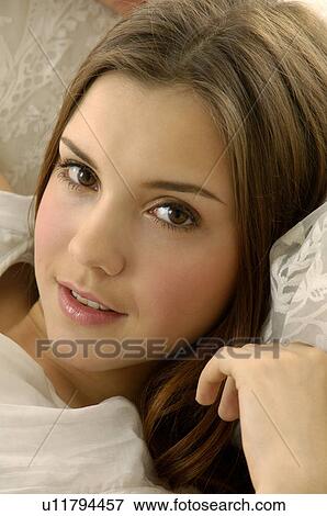 Portrait of a young woman grinning View Large Photo Image Stock Photo - Portrait of a young woman grinning. Fotosearch