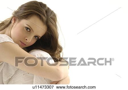 Portrait of a young woman hugging her knees View Large Photo Image Stock Photo - Portrait of a young woman hugging her knees. Fotosearch