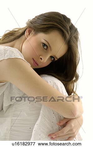 Portrait of a young woman hugging her knees View Large Photo Image Stock Photo - Portrait of a young woman hugging her knees. Fotosearch