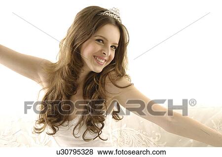 Portrait of a young woman wearing a tiara and smiling View Large Photo Image Stock Photo - Portrait of a young woman wearing a tiara and smiling. Fotosearch