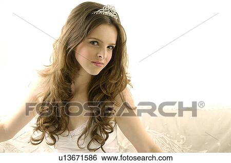 Portrait of a young woman wearing a tiara View Large Photo Image Stock Photograph - Portrait of a young woman wearing a tiara. Fotosearch