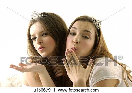 Portrait of two young women wearing tiaras and puckering View Large Photo Image Stock Image - Portrait of two young women wearing tiaras and puckering. Fotosearch
