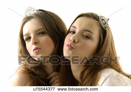 Portrait of two young women wearing tiaras and puckering View Large Photo Image Stock Photo - Portrait of two young women wearing tiaras and puckering. Fotosearch