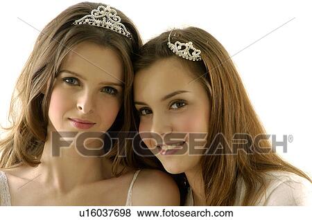 Portrait of two young women wearing tiaras View Large Photo Image Stock Photo - Portrait of two young women wearing tiaras. Fotosearch