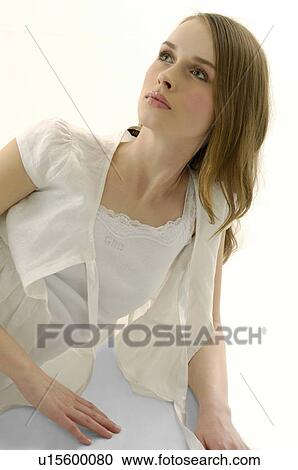 Young woman leaning on her elbow and looking away View Large Photo Image Stock Image - Young woman leaning on her elbow and looking away. Fotosearch