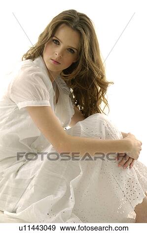 Portrait of a young woman hugging her knees View Large Photo Image Stock Photo - Portrait of a young woman hugging her knees. Fotosearch
