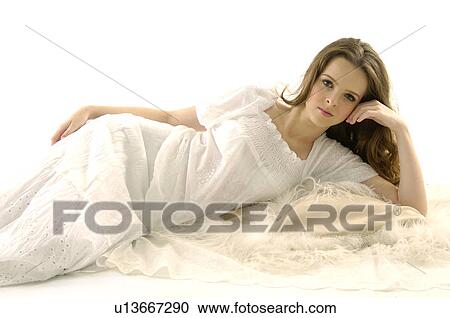 Stock Image - Portrait of a young woman lying on the floor. Fotosearch