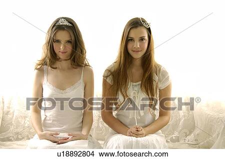 Portrait of two young women wearing tiaras and smiling View Large Photo Image Picture - Portrait of two young women wearing tiaras and smiling. Fotosearch