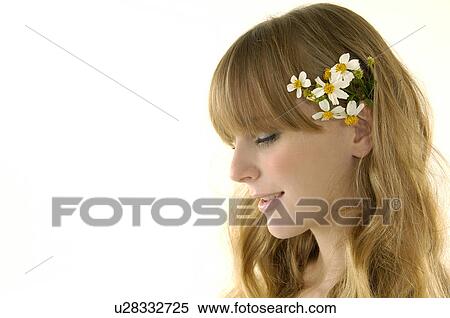 Close-up of a young woman wearing flower in her hair View Large Photo Image Stock Photography - Close-up of a young woman wearing flower in her hair. Fotosearch
