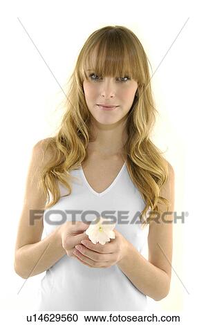 Portrait of a young woman holding a flower View Large Photo Image Stock Image - Portrait of a young woman holding a flower. Fotosearch