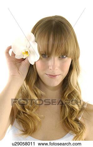 Portrait of a young woman holding a flower View Large Photo Image Stock Image - Portrait of a young woman holding a flower. Fotosearch