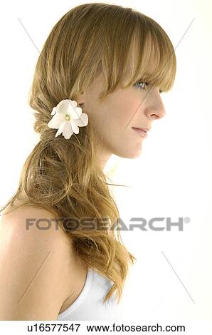 Side profile of a young woman wearing a flower in her hair View Large Photo Image Stock Photo - Side profile of a young woman wearing a flower in her hair. Fotosearch