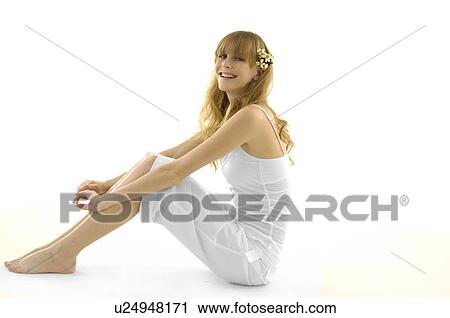 Side profile of a young woman wearing flowers in her hair and smiling View Large Photo Image Stock Image - Side profile of a young woman wearing flowers in her hair and smiling. Fotosearch