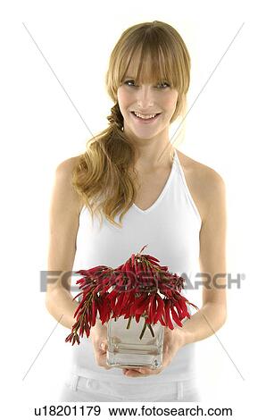 Portrait of a young woman holding a flower pot and smiling View Large Photo Image Stock Photo - Portrait of a young woman holding a flower pot and smiling. Fotosearch